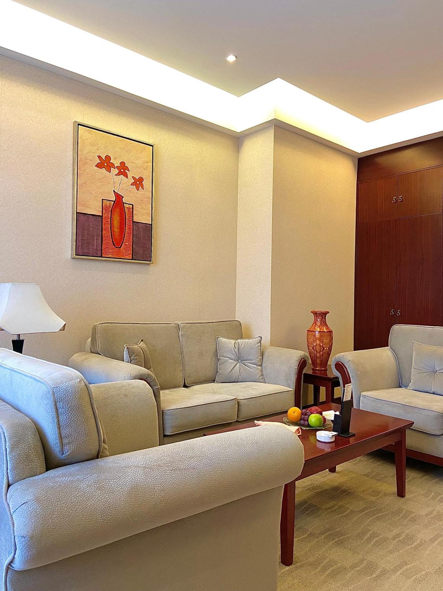 Beijing Palace Soluxe Hotel Astana Buitenkant foto A living room in a typical apartment
